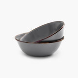 The two bowls sit on a white background with one stacked inside of the other.
